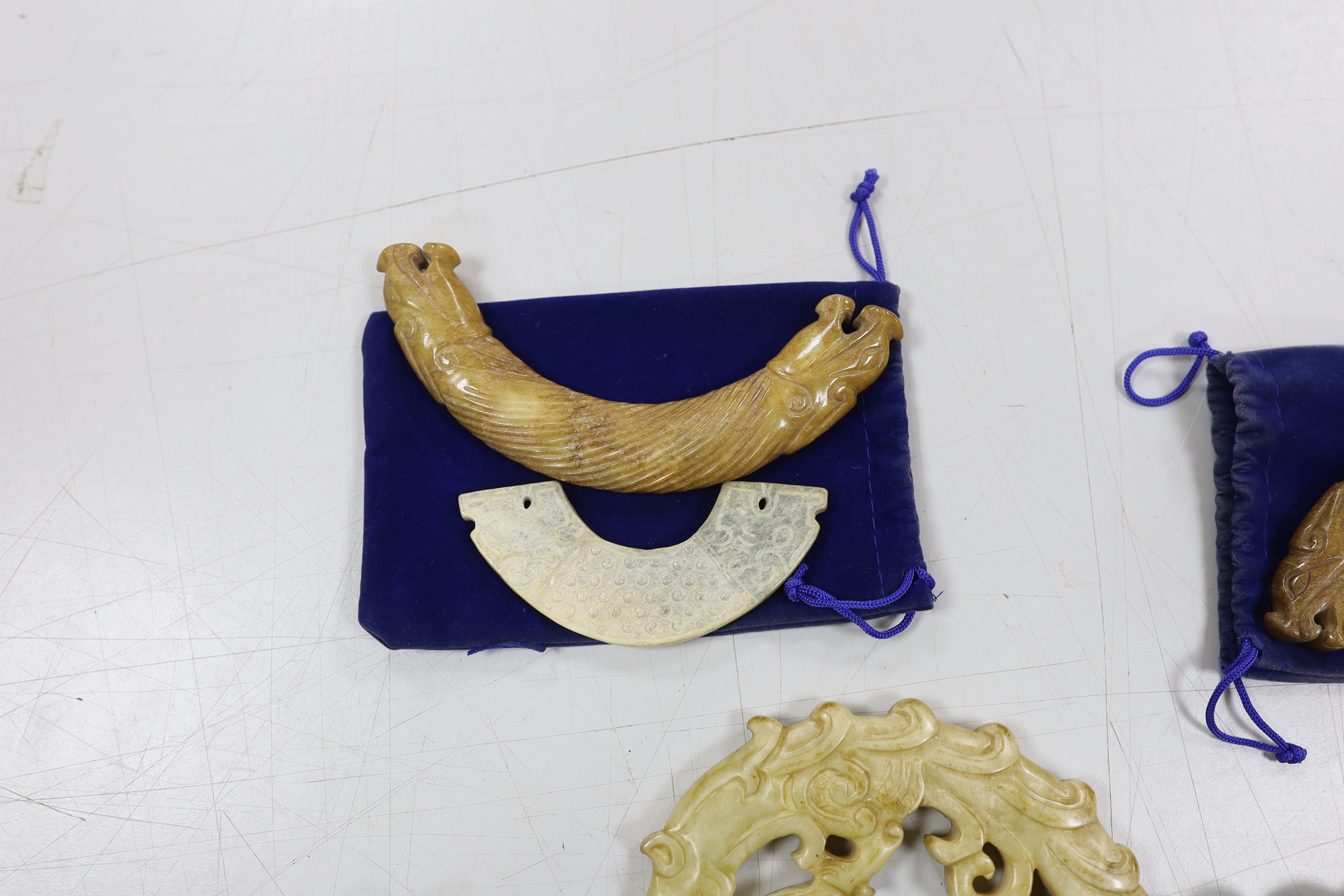 Three Chinese jade carvings, two huang, a large hardstone pendant and disc, largest overall 90cm in length (4)